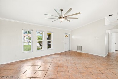 Empty room with a ceiling fan, crown molding, vaul