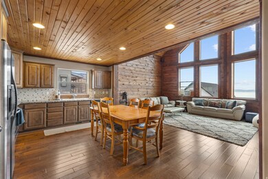 Dining area featuring wooden ceiling, plenty of natural light, recessed lighting, dark wood-type flooring, and wood walls