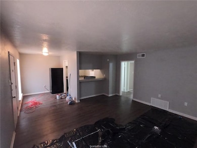 Unfurnished living room featuring visible vents, d