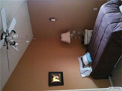 One of three bedrooms, each with a fan and high ce