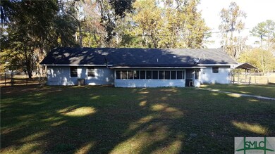 Rear of home with patio enclosure.