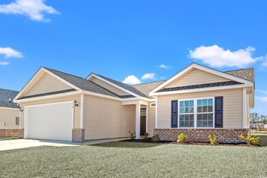View of front of property featuring a garage and a front yard