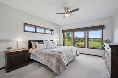 Luxurious primary suite is a retreat in itself with scenic views out to the east and beyond the horizon.