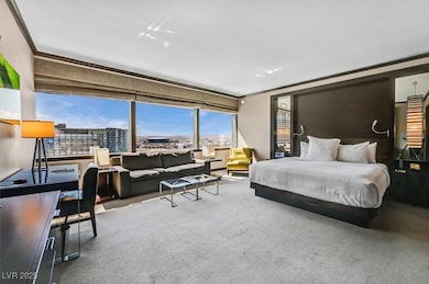 Carpeted bedroom with a view of city