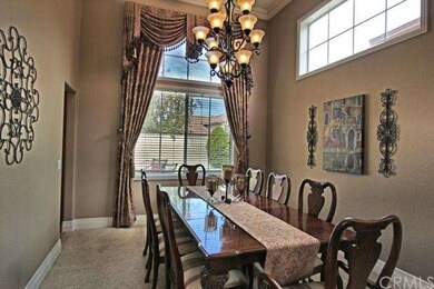 Formal Dining Room has custom drapery and Gorgeous