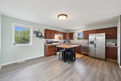 Check out the island and stainless steel fridge!