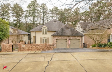 French country home with an attached garage, a shi