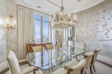 Dining space with crown molding, a notable chandel