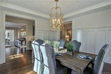 Large, sunny dining room with wainscoting and beau