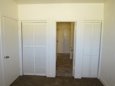 Front bedroom has two closets flanking door to mai