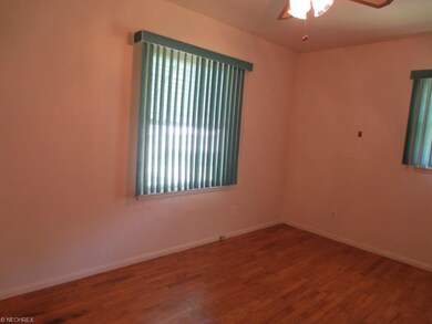 Master bedroom with vertical blinds, ceiling fan a