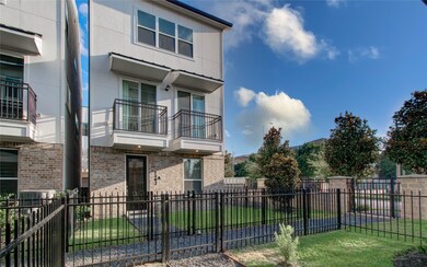 Modern two-story townhouse with a brick and stucco