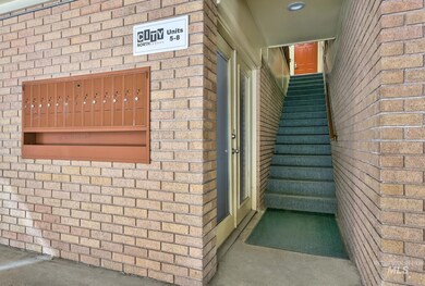 View of exterior entry featuring brick siding