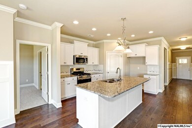 White Bento Shaker cabinets, Upgraded flooring and a gas range. Plenty of storage.