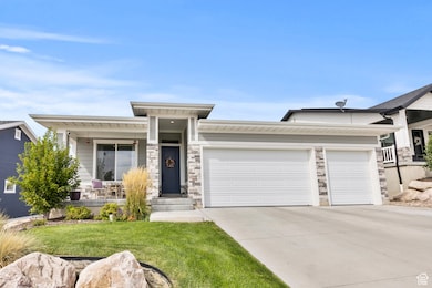 View of front of home with concrete driveway, a garage, stone siding, covered porch, and a front lawn
