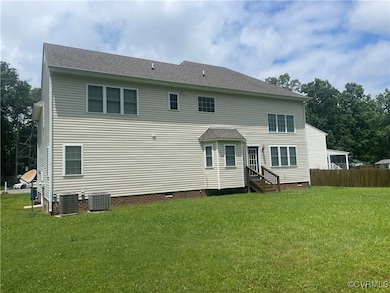 Back of house featuring entry steps and crawl spac