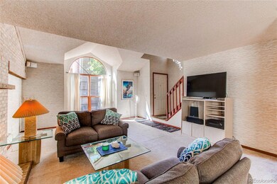 Living room, main door and second level staircae