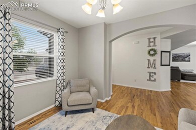 Sitting room with an inviting chandelier and hardw
