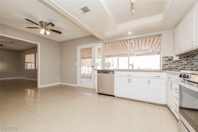 Kitchen with dishwasher, stove, light countertops,