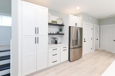 Kitchen featuring white cabinets, light wood-type 