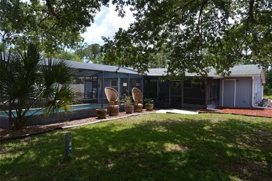 BACK OF HOME WITH POOL AND NICE OUTDOOR SITTING AR