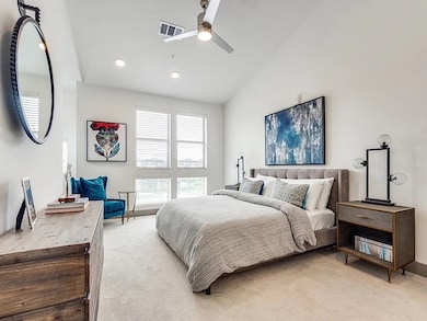 Carpeted bedroom with vaulted ceiling, ceiling fan, and recessed lighting