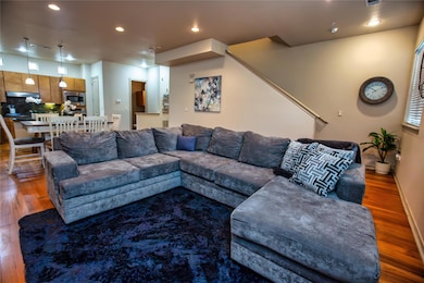 Living room with wood finished floors and recessed