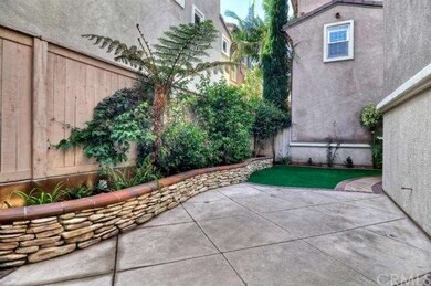 CHARMING REAR YARD WITH CUSTOM HARDSCAPE AND FOUNT
