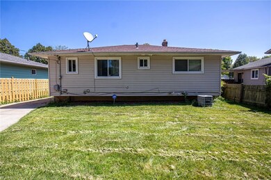 Back of house with a yard