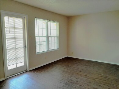 Spare room featuring wood finished floors, a heal
