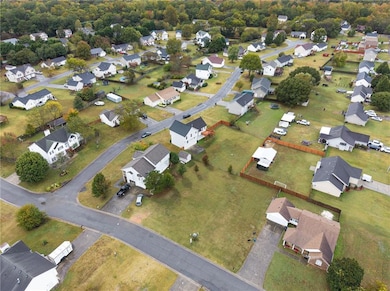 Aerial overview of property's location featuring nearby suburban area