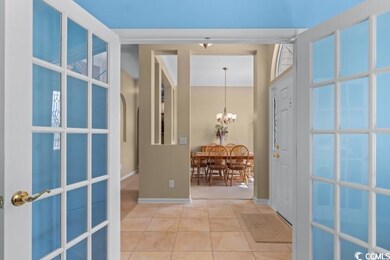 Corridor with crown molding, tile patterned floori