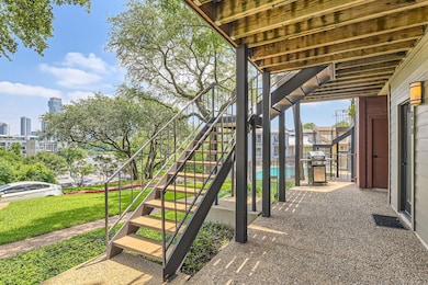 View of patio featuring stairs and a grill