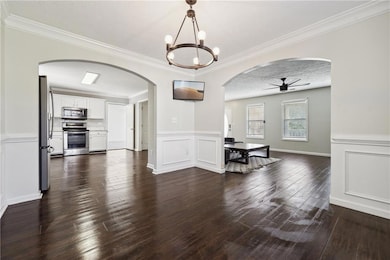 Dining space featuring a textured ceiling, dark wo