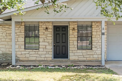 Entrance to property with stone siding, an attach