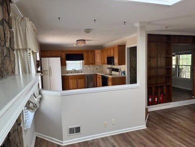 Kitchen featuring visible vents, dishwasher, range