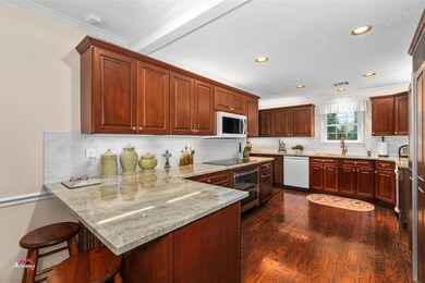 Kitchen featuring light stone counters, a kitchen 