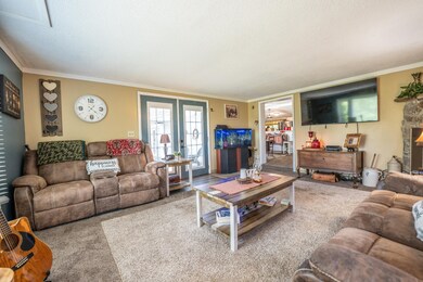 Living room with accent wall, carpet flooring and french doors! 348 Turkey Scratch Rd Spencer, TN 38585