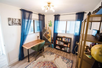 Office space featuring a notable chandelier, a we