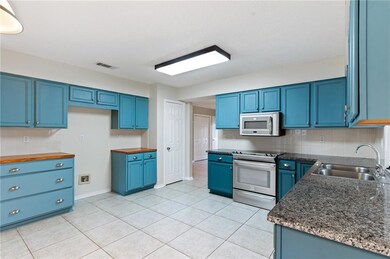 Kitchen with granite counter tops and decorator co