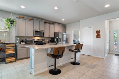 Kitchen featuring a kitchen breakfast bar, applia