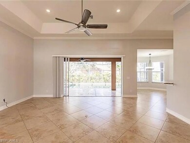 Tiled spare room featuring a raised ceiling and ce