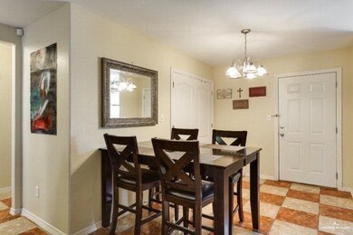 Dining space featuring a notable chandelier, baseboards, and light floors