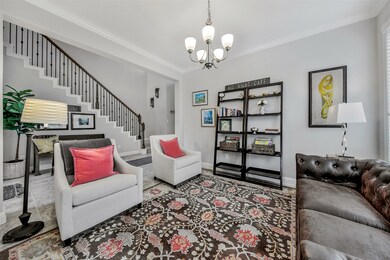 Beautiful formal dining room is currently used as a sitting area and offers neutral tile flooring, pretty chandelier, and crown molding. This room has direct access to the kitchen via the butler's pantry.