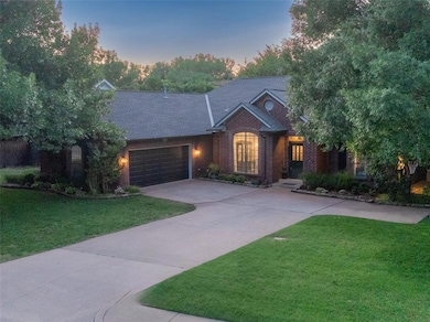 View of front facade with concrete driveway, a garage, a front yard, brick siding, and roof with shingles