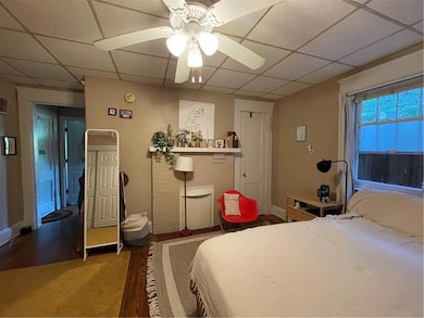 Bedroom featuring a paneled ceiling, baseboards, a