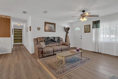 Living area featuring ceiling fan, wood finished floors, baseboards, and built in features