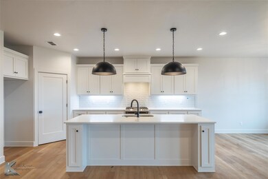 Kitchen with white cabinetry, sink, and a kitchen 