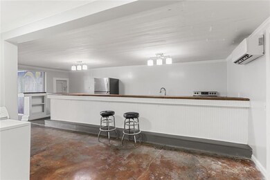Walk into the kitchen area with the bar featured i