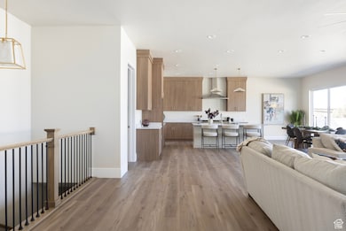 Living room with light wood finished floors and recessed lighting